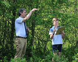 Renbrook School teacher pointing to tree with student