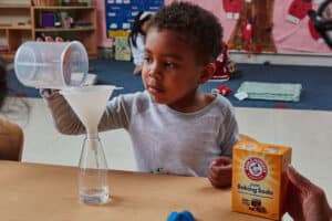 child doing experiment with baking soda