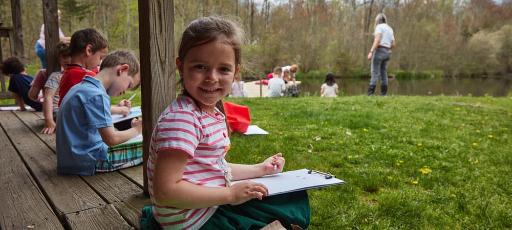 Kids coloring on pond house porch