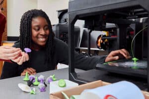 girl creating on 3D printer
