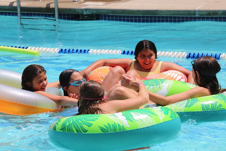 Kids floating on tubes in pool