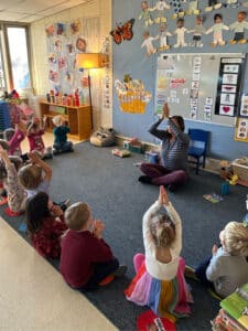 preschool teacher demonstrating mindfulness to students