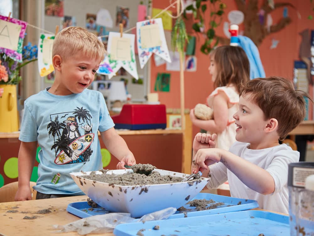 two young boys making paper pulp