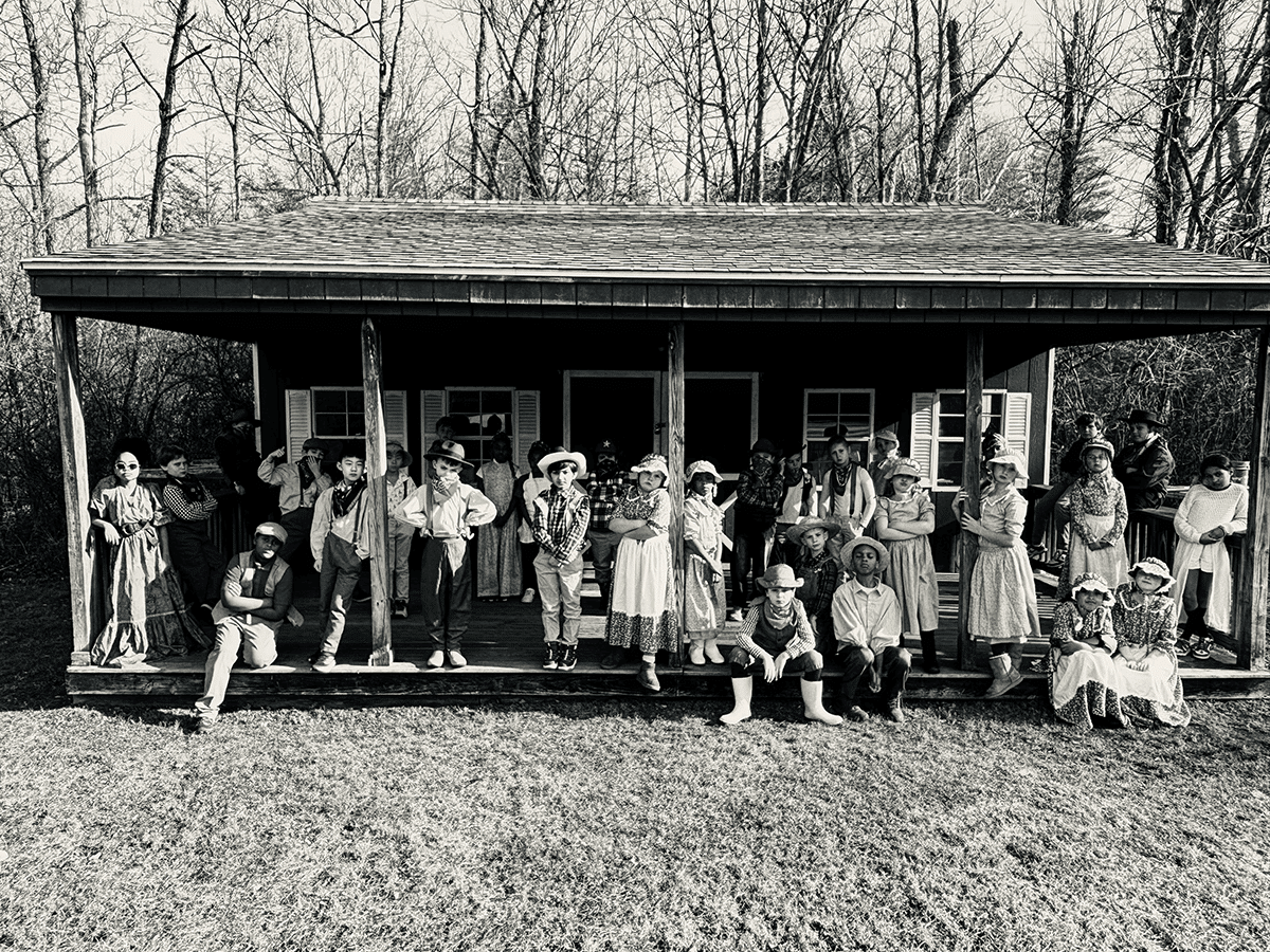 Group of third grade students posing as settlers 