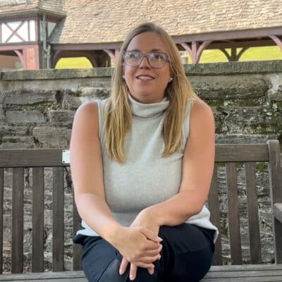 female parent sitting on a bench for an interview